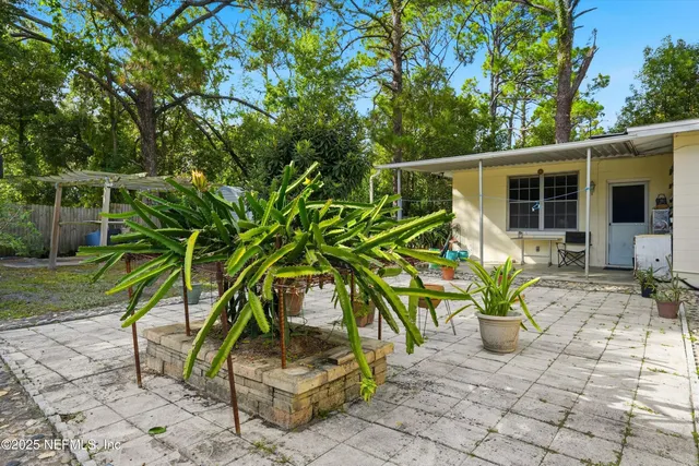 a backyard of a house with table and chairs