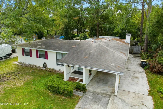 an aerial view of a house with a yard