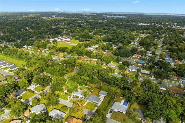 a view of a city with lush green forest