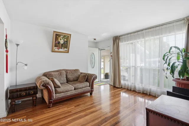 a living room with furniture and a large window