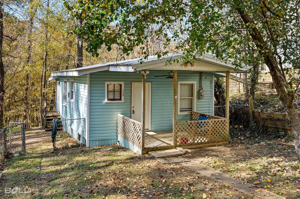 333 Canal Street Ringgold, LA 71068 - Photo 33 of 33 a view of a wooden house with a large tree and wooden fence