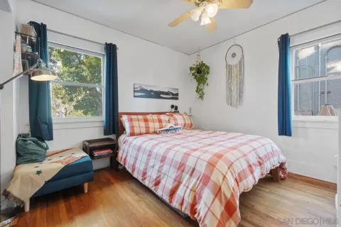 a bedroom with a bed window and a table