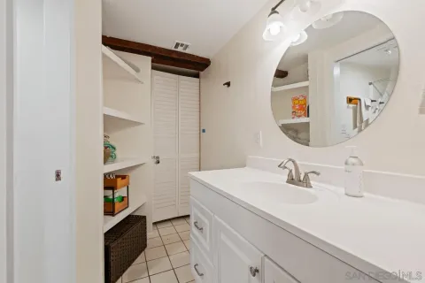 a bathroom with a sink a vanity and a mirror