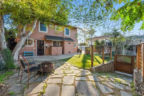 a view of backyard with swimming pool and furniture