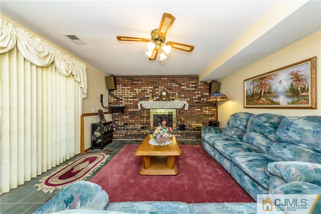 263 Ford Road Howell, NJ 07731 - Photo 22 of 33 a living room with furniture and a chandelier
