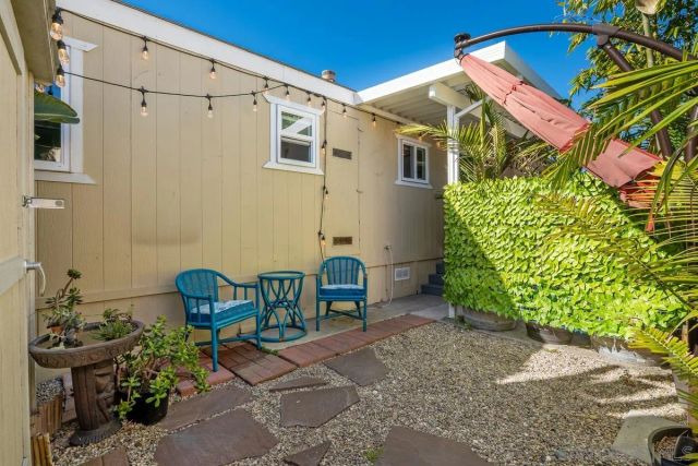 a backyard of a house with outdoor seating
