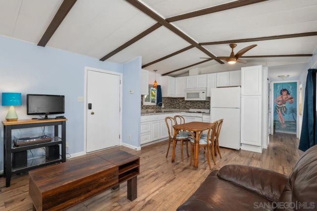 a dining room with furniture and wooden floor