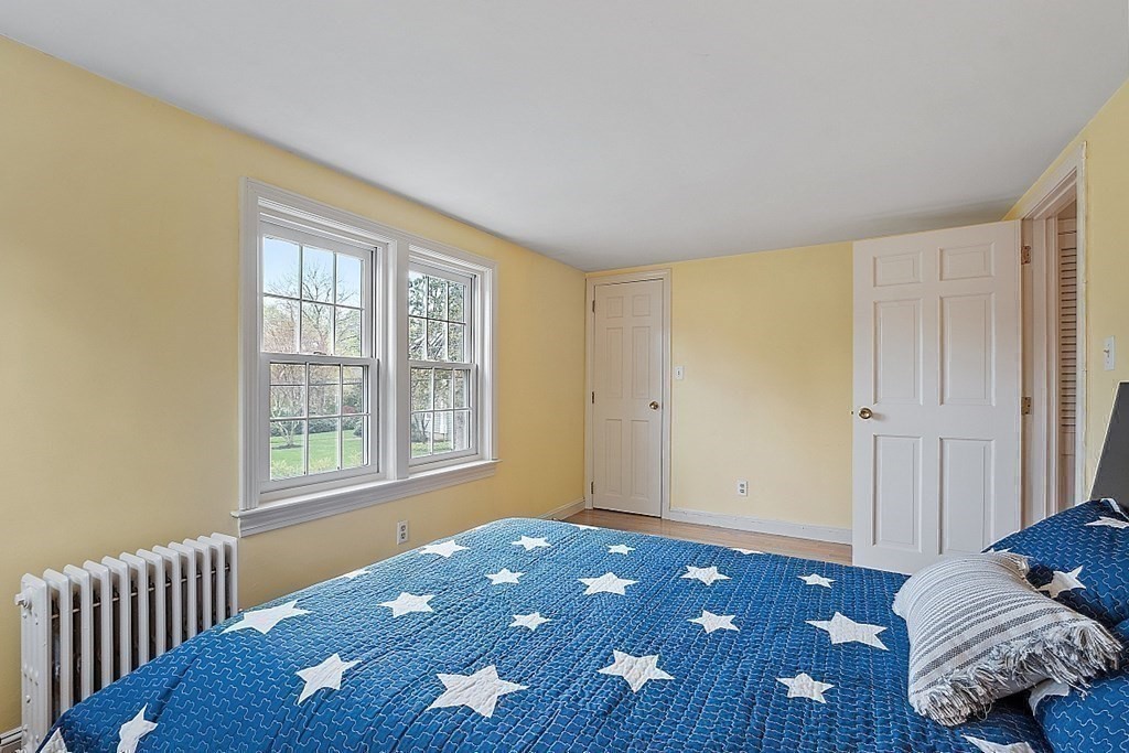 5 Gleason Road Lexington, MA 02420 - Photo 16 of 32 a bedroom with a bed and wooden floor