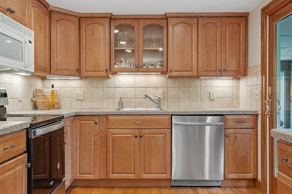 5 Gleason Road Lexington, MA 02420 - Photo 6 of 32 a kitchen with stainless steel appliances granite countertop a refrigerator and cabinets