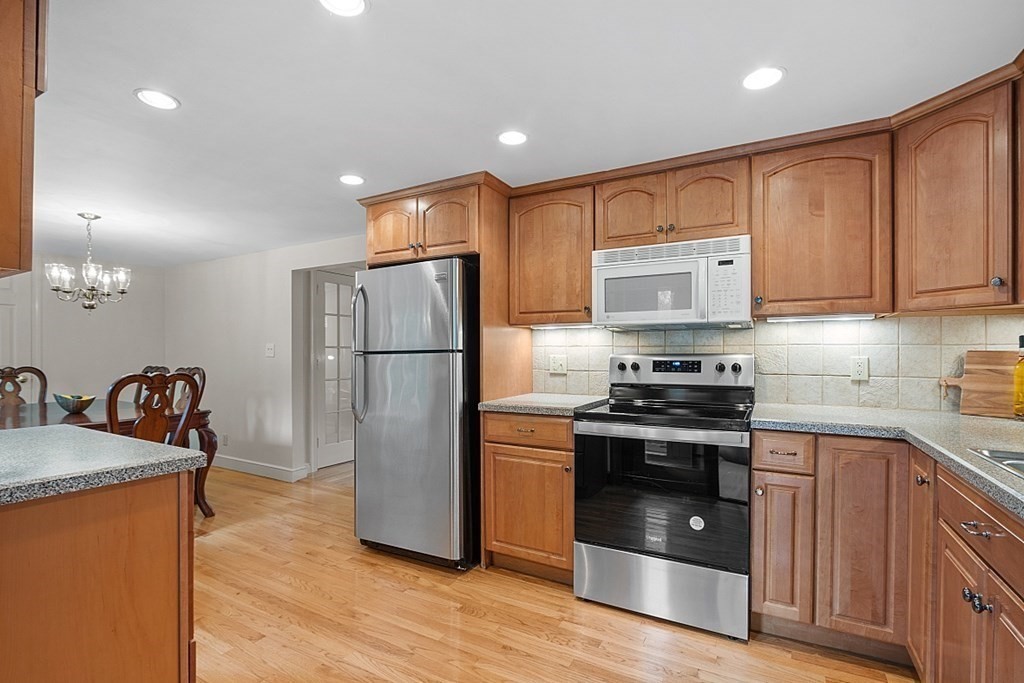 5 Gleason Road Lexington, MA 02420 - Photo 7 of 32 a kitchen with granite countertop a refrigerator stove and sink