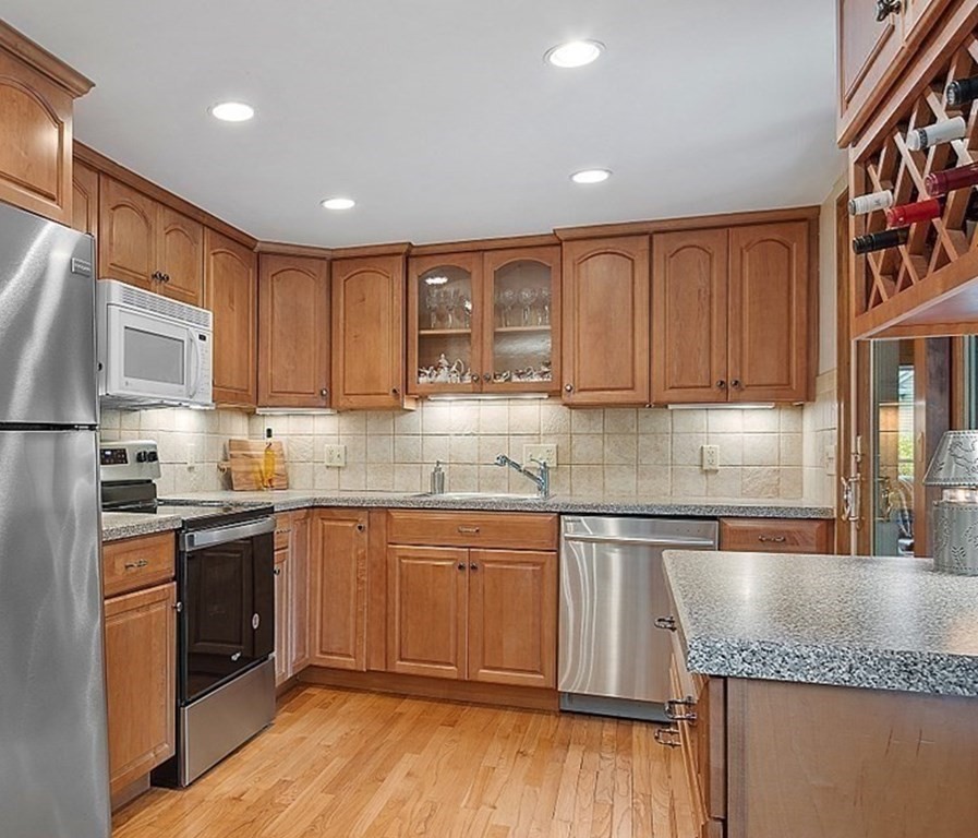 5 Gleason Road Lexington, MA 02420 - Photo 8 of 32 a kitchen with granite countertop stainless steel appliances and wooden cabinets
