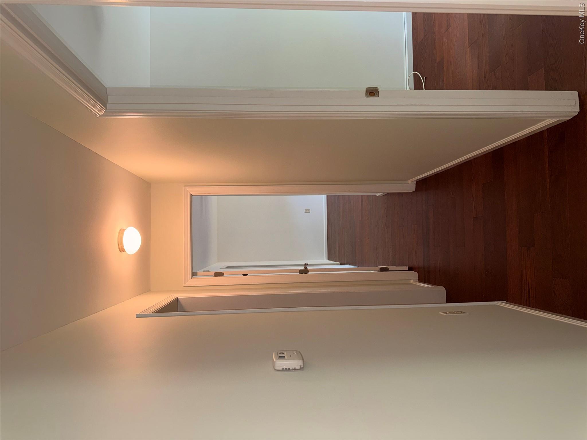 1661 Old Country Road, Unit 516 Riverhead, NY 11901 - Photo 26 of 50 a view of a hallway with wooden floor