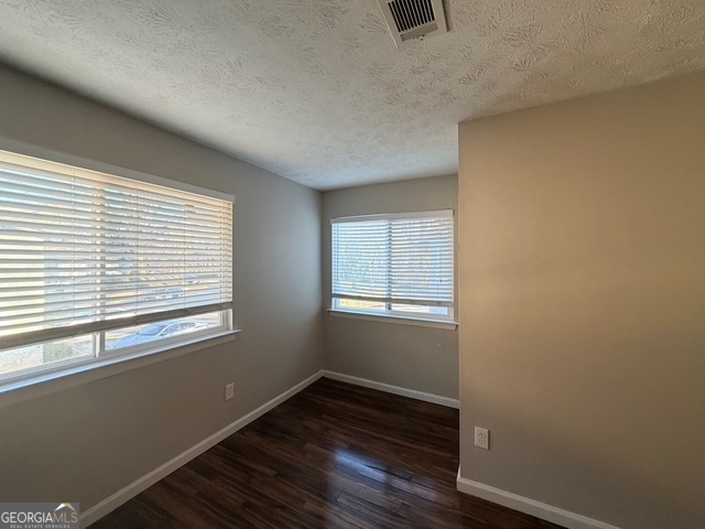 3810 Kensingwood Trace Decatur, GA 30032 - Photo 5 of 16 a view of an empty room with wooden floor and a window