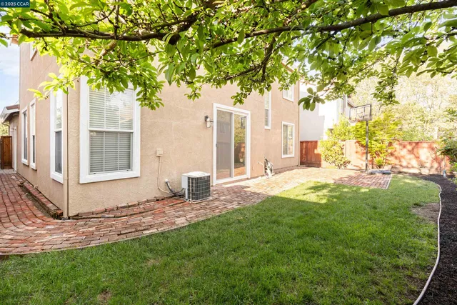 a backyard of a house with table and chairs