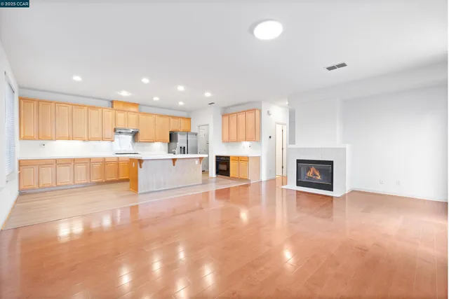 a view of a kitchen with a sink and a fireplace