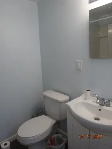 a white toilet sitting next to a bathroom sink