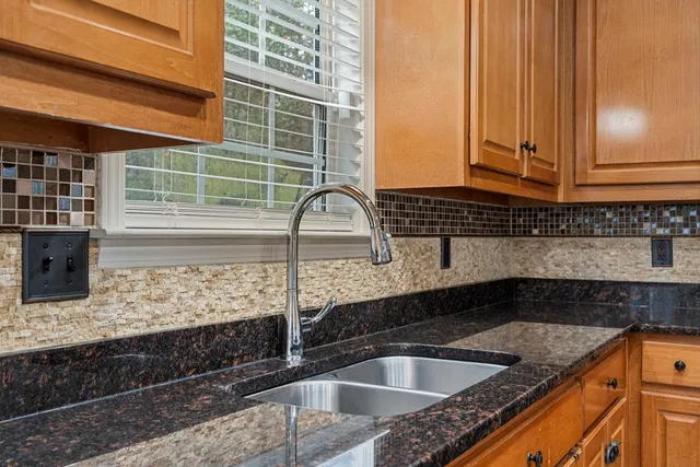 a kitchen with a sink and a large window