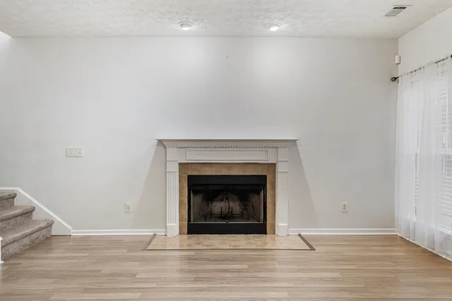 a living room with a fireplace and a wooden floor