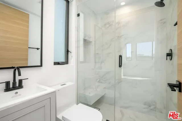 a bathroom with a toilet sink and shower