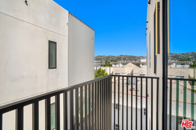 a view of a balcony with wooden floor