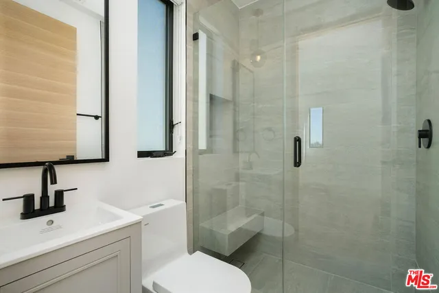 a bathroom with a toilet sink and shower