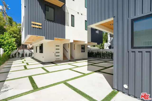 a view of a house with backyard and sitting area