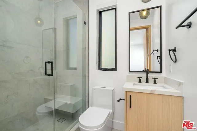 a bathroom with a toilet sink and shower