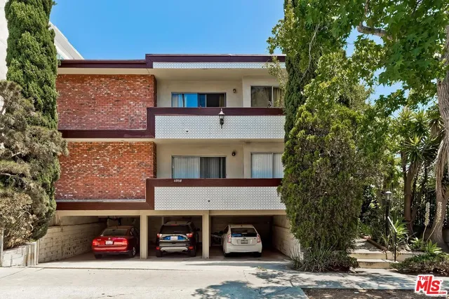 a front view of a building with parking