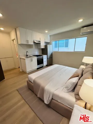 a large white bed in a white room