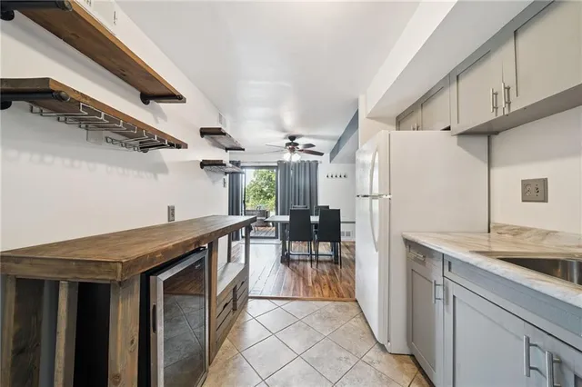 a kitchen with stainless steel appliances granite countertop a refrigerator and a sink