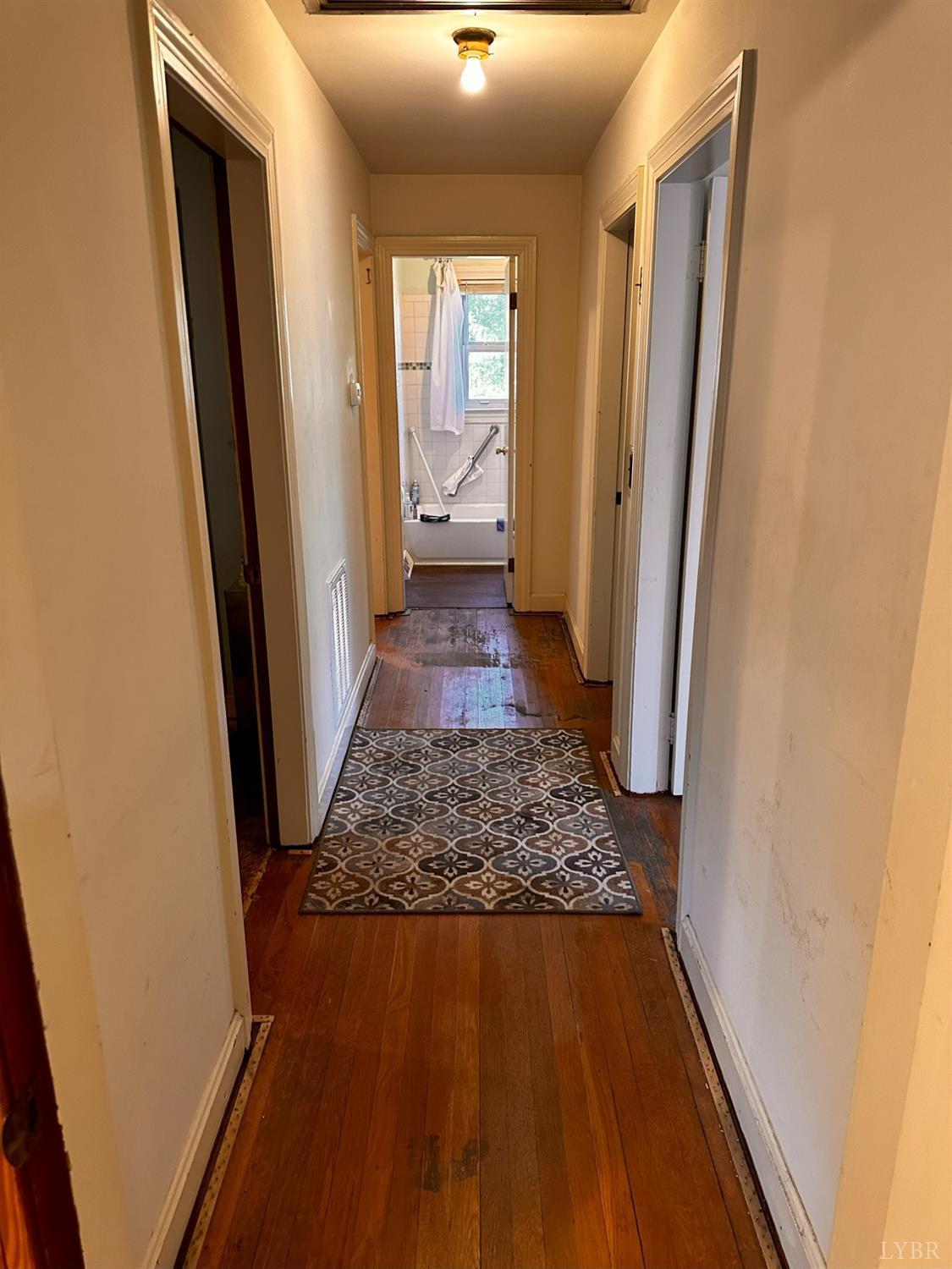 1724 Stone Mill Road Hurt, VA 24563 - Photo 17 of 37 a view of a hallway with wooden floor and staircase