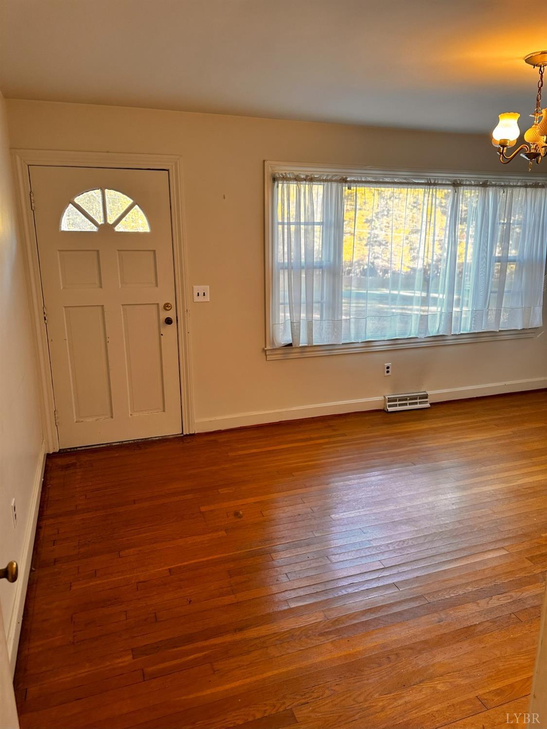 1724 Stone Mill Road Hurt, VA 24563 - Photo 20 of 37 an empty room with wooden floor and windows