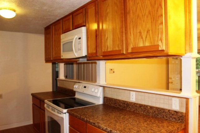 204 Hickman Road Forsyth, GA 31029 - Photo 6 of 13 a kitchen with granite countertop sink and cabinets