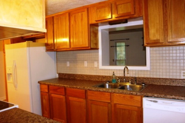 204 Hickman Road Forsyth, GA 31029 - Photo 7 of 13 a kitchen with stainless steel appliances granite countertop a sink and a cabinets