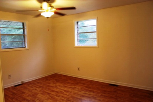 204 Hickman Road Forsyth, GA 31029 - Photo 9 of 13 an empty room with a window and wooden floor