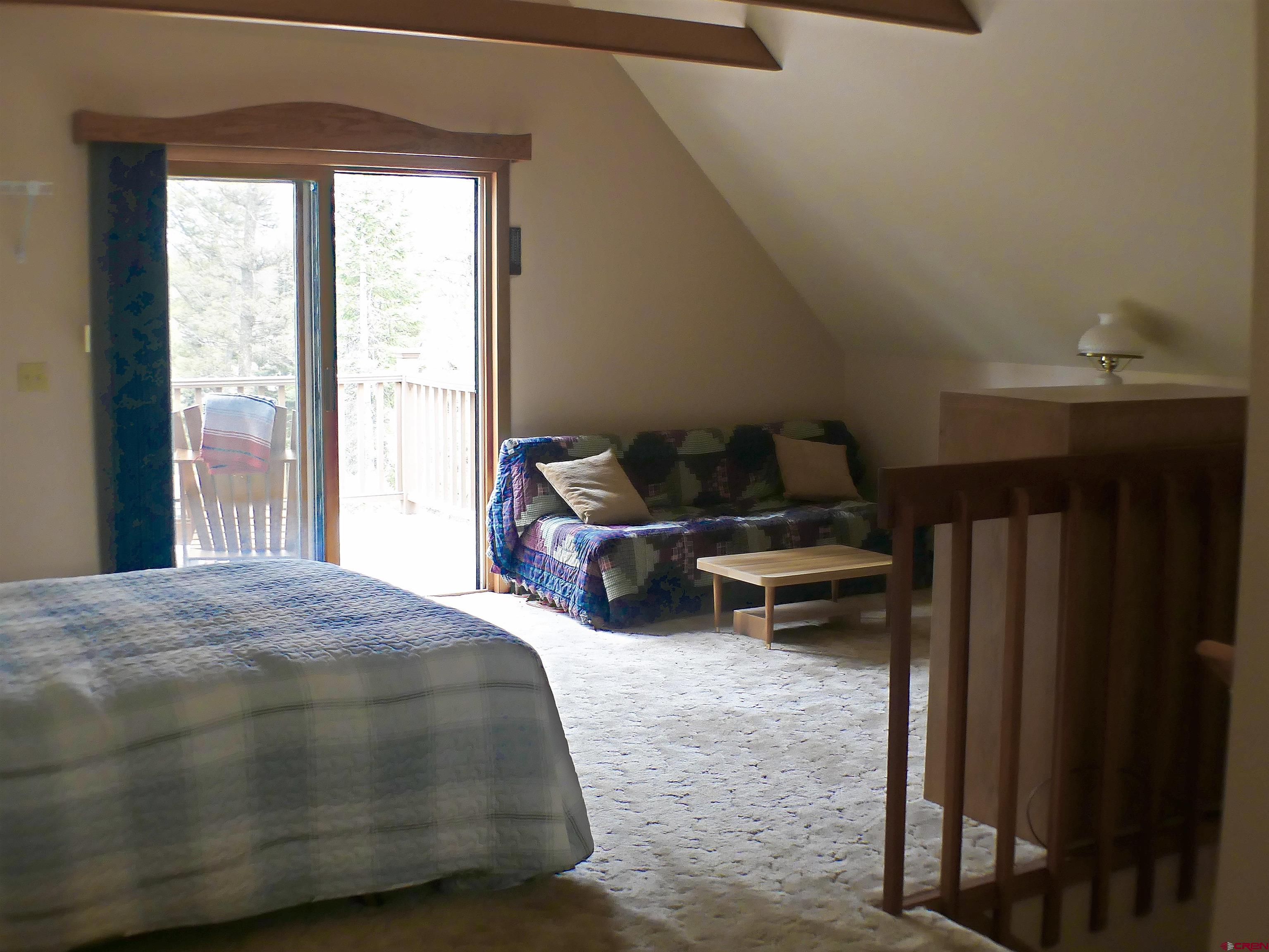 453 Ute Road Cimarron, CO 81220 - Photo 12 of 18 a bedroom with bed and a window