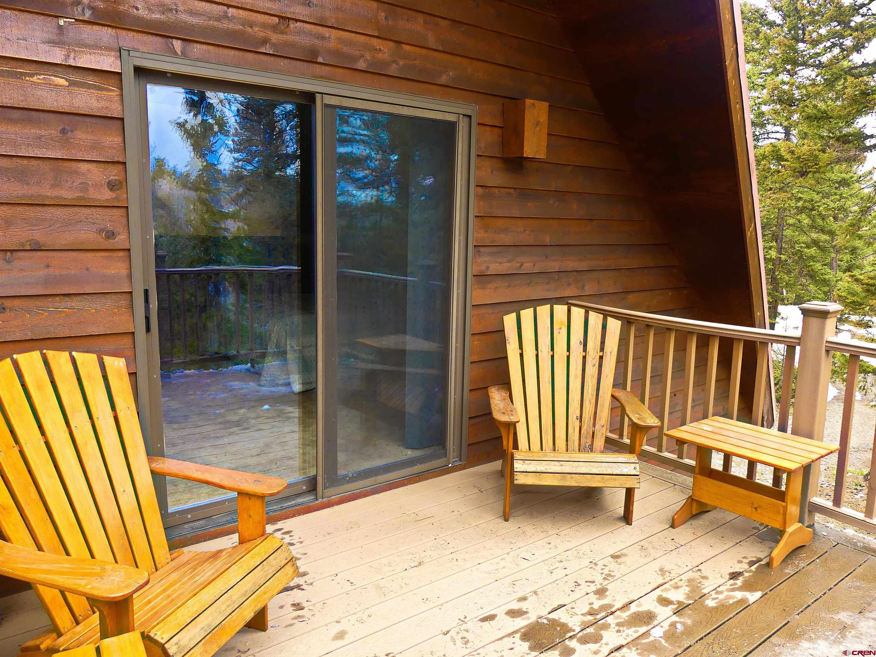 453 Ute Road Cimarron, CO 81220 - Photo 14 of 18 a view of a porch with a door and chair