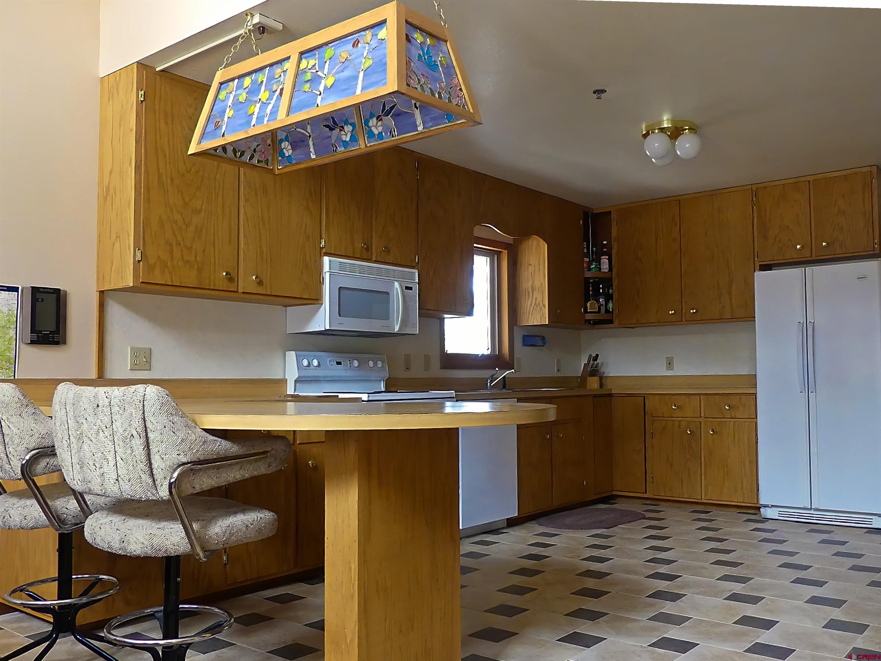 453 Ute Road Cimarron, CO 81220 - Photo 5 of 18 a kitchen with stainless steel appliances granite countertop a sink and cabinets