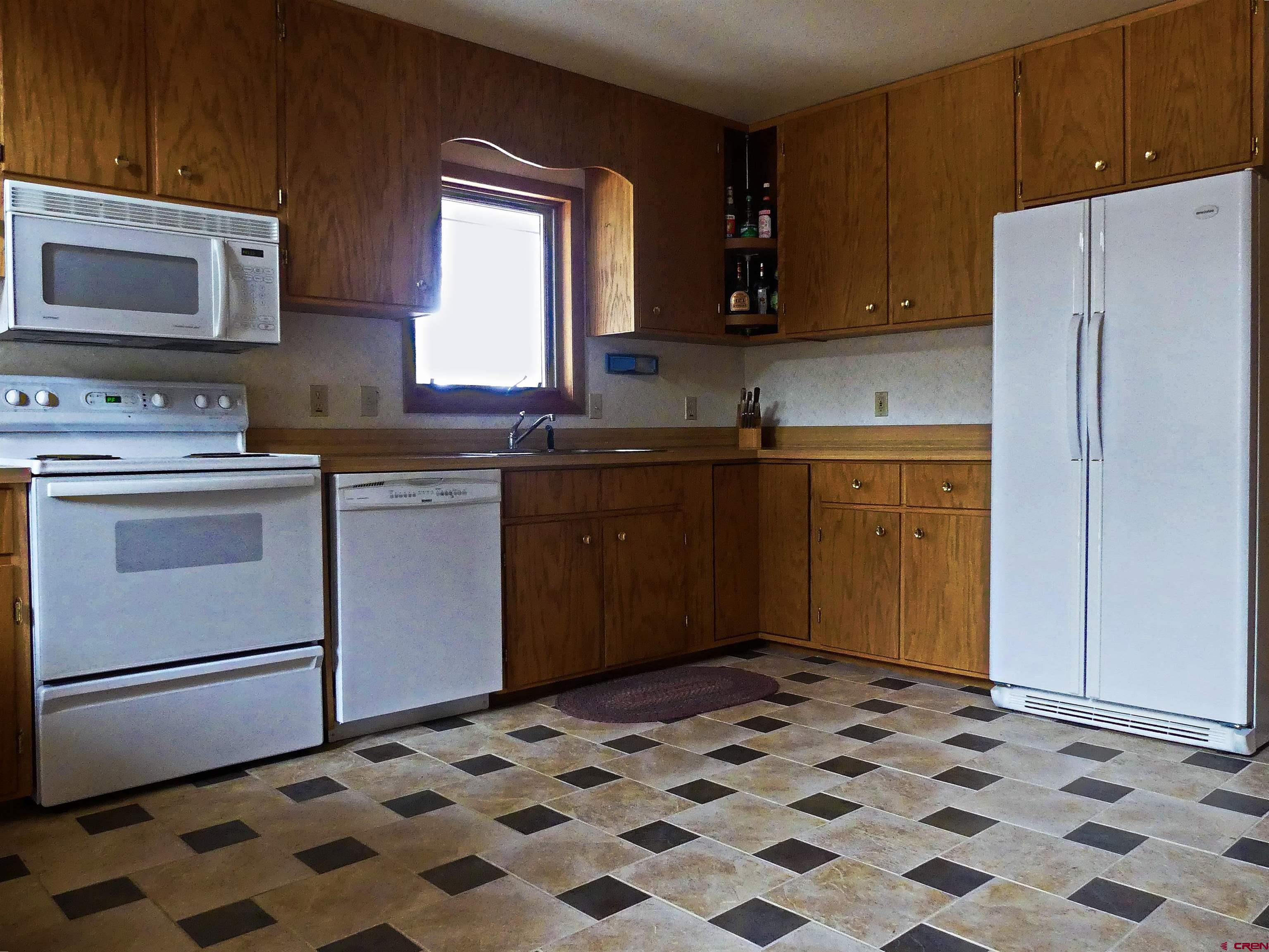 453 Ute Road Cimarron, CO 81220 - Photo 6 of 18 a kitchen with stainless steel appliances granite countertop a sink stove and refrigerator