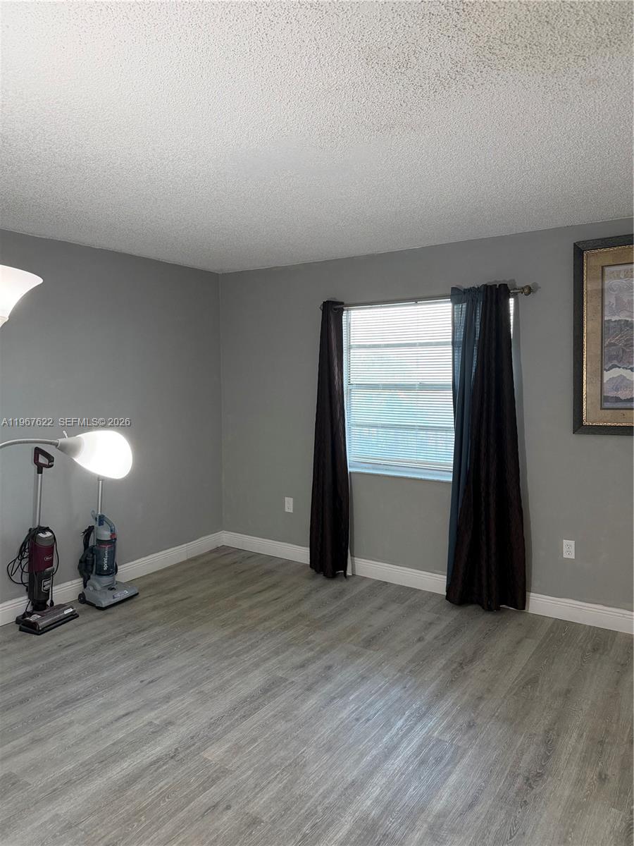 3910 Inverrary Boulevard, Unit 803B Lauderhill, FL 33319 - Photo 13 of 18 a view of a room with wooden floor and a window