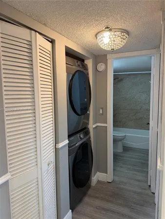 a view of a hallway with washer and dryer