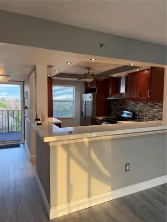 a view of a living room and kitchen