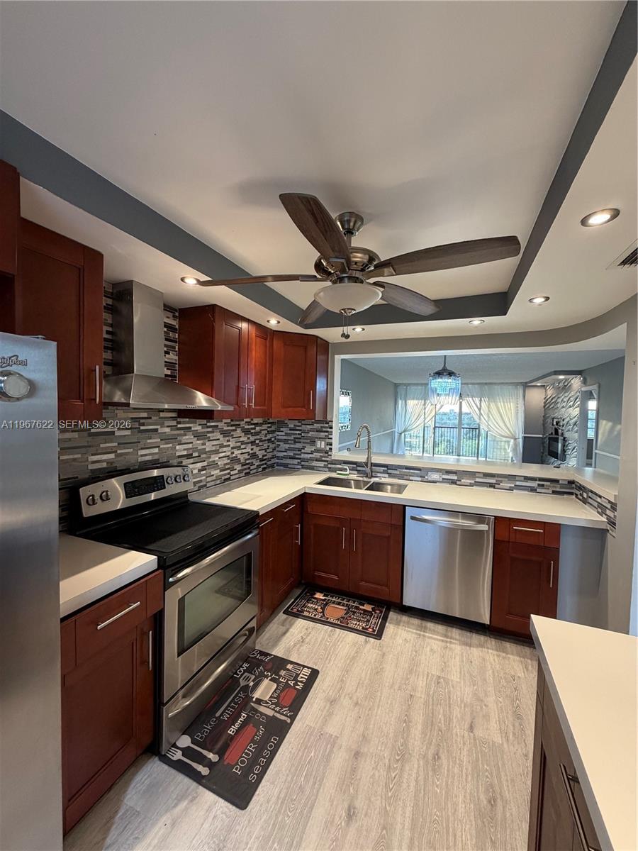 3910 Inverrary Boulevard, Unit 803B Lauderhill, FL 33319 - Photo 4 of 18 a kitchen with stainless steel appliances granite countertop a stove and a sink