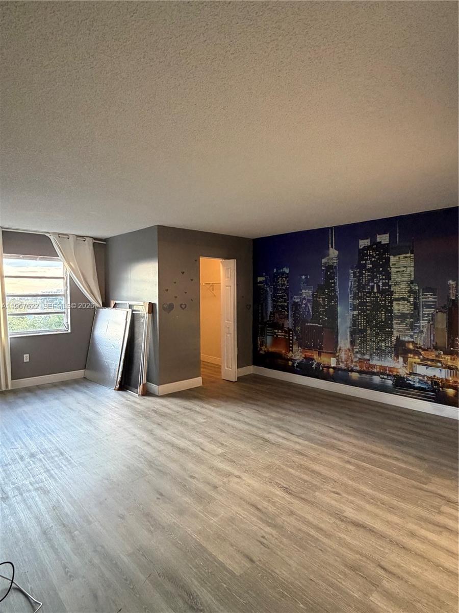 3910 Inverrary Boulevard, Unit 803B Lauderhill, FL 33319 - Photo 6 of 18 a view of a livingroom with wooden floor and window