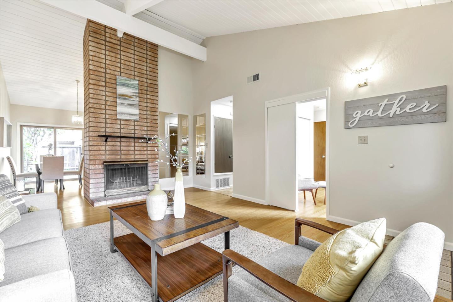 146 Brahms Way Sunnyvale, CA 94087 - Photo 4 of 24 a living room with furniture a fireplace and a table