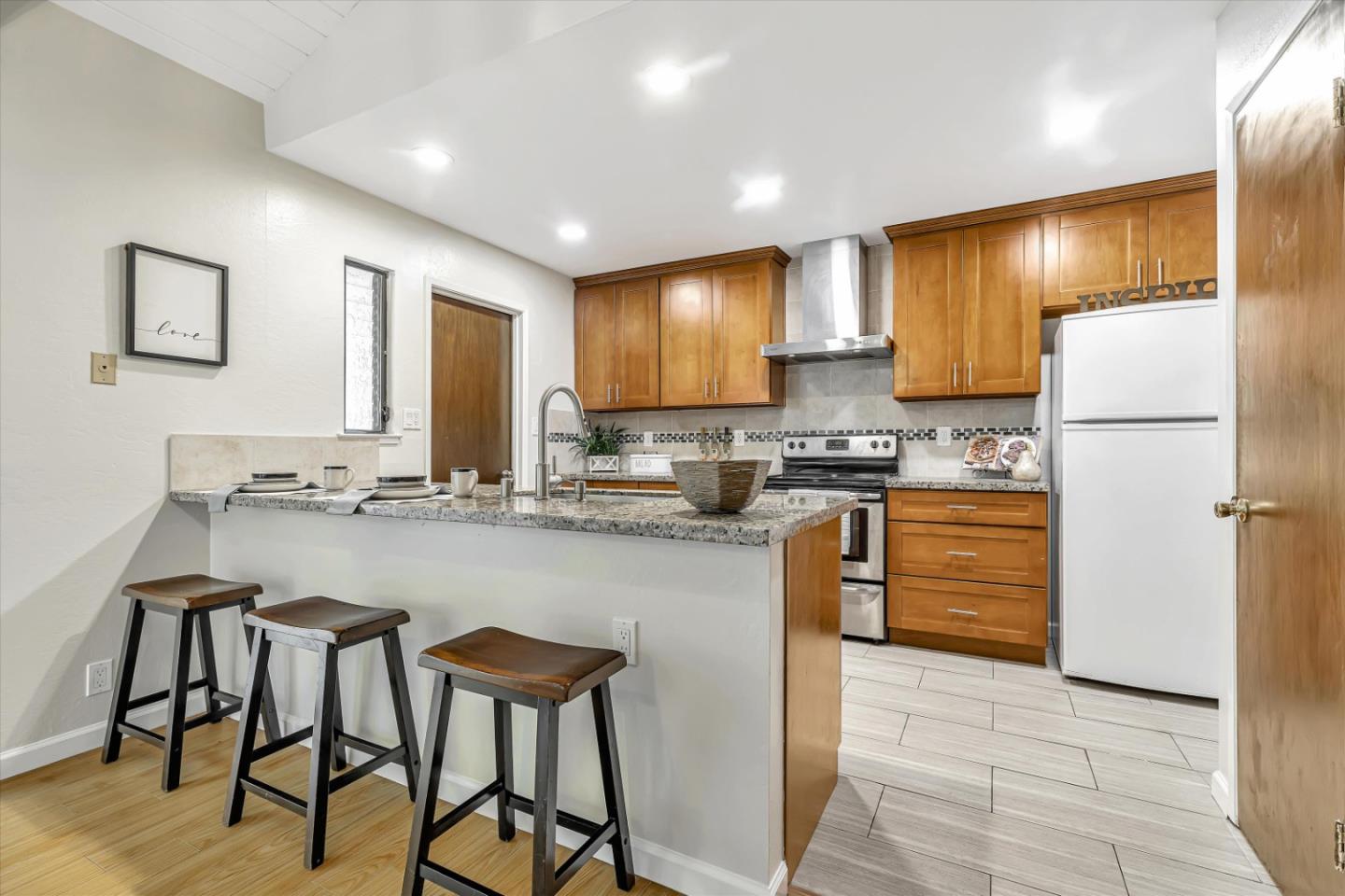 146 Brahms Way Sunnyvale, CA 94087 - Photo 5 of 24 a kitchen with stainless steel appliances granite countertop a stove a sink a refrigerator and a refrigerator