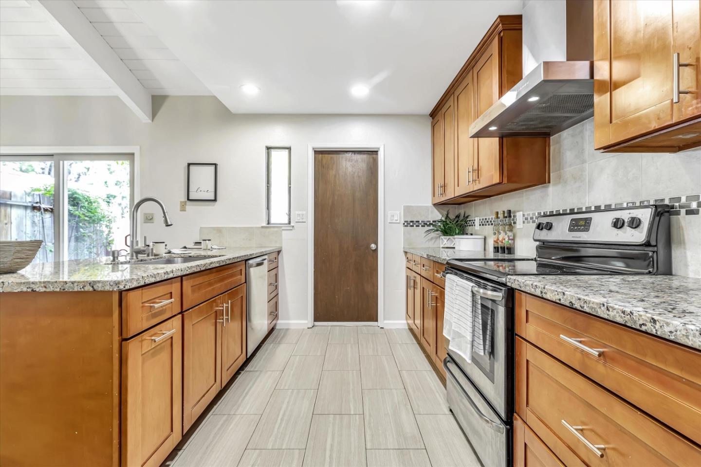 146 Brahms Way Sunnyvale, CA 94087 - Photo 7 of 24 a large kitchen with stainless steel appliances granite countertop a sink and cabinets