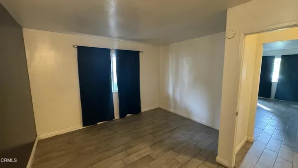 a view of hallway with wooden floor