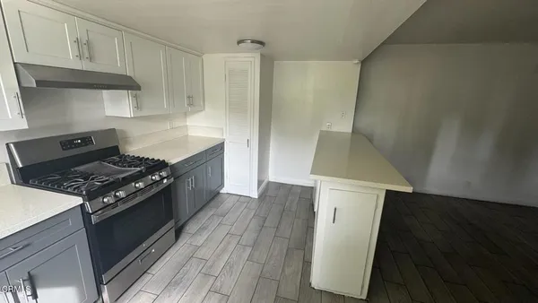 a kitchen with a stove and a refrigerator