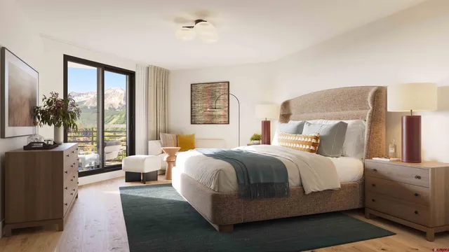 a bedroom with a large bed and a couch